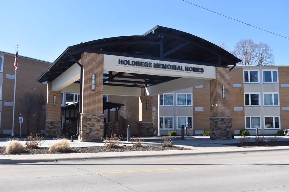 This image shows the front entrance of Holdrege Memorial Homes with brick columns and a canopy.