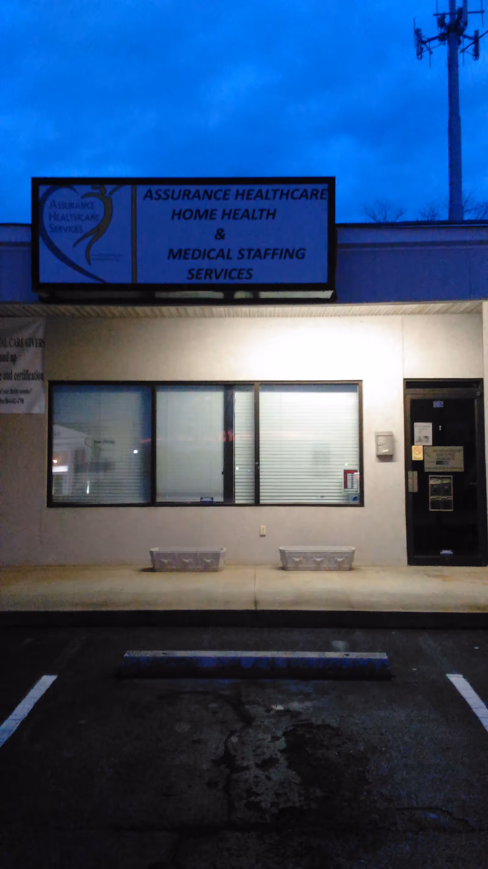 Exterior view of a healthcare facility storefront with sign and windows.