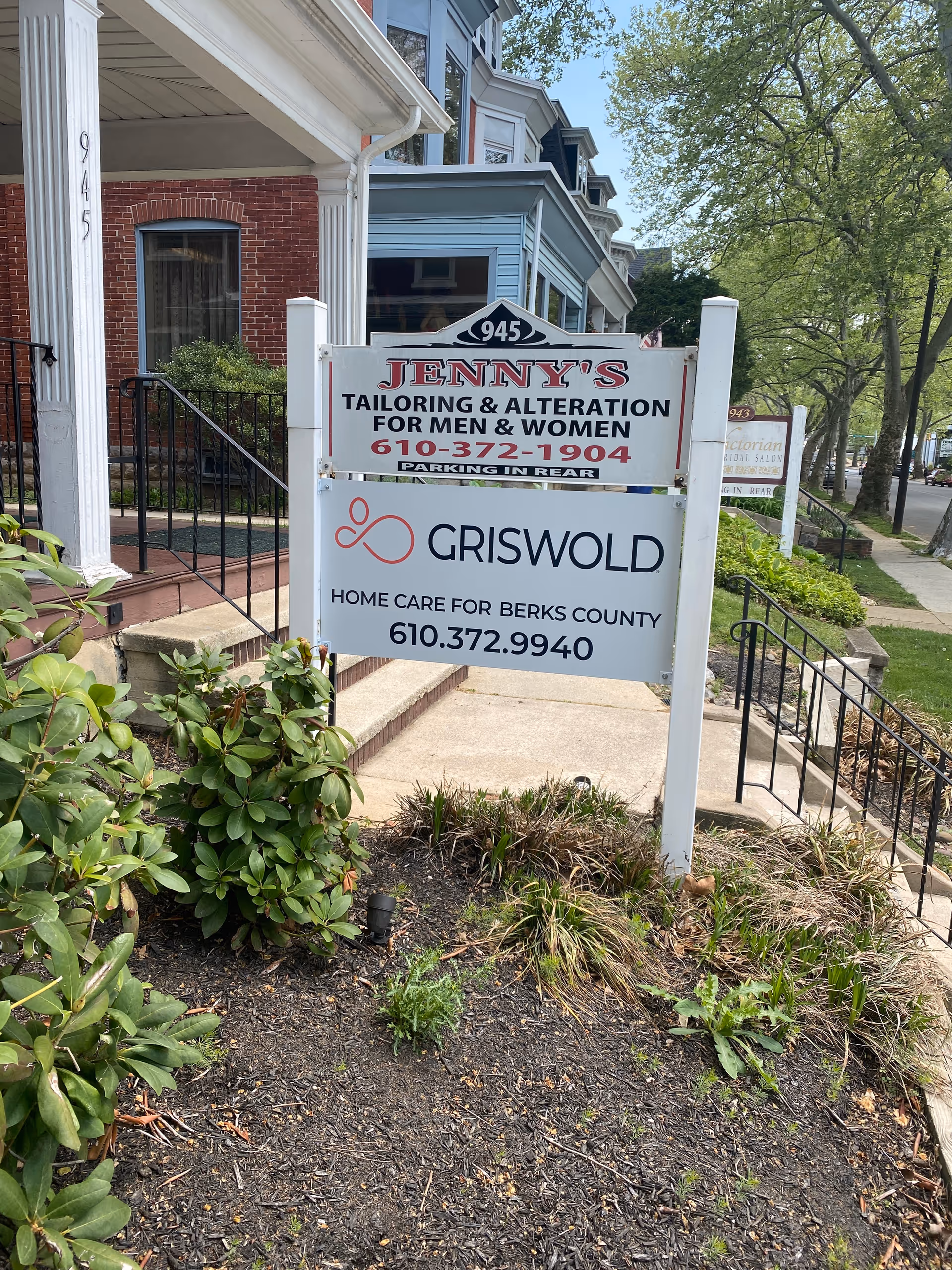 Front yard sign for Griswold Home Care Berks County beside a brick building.
