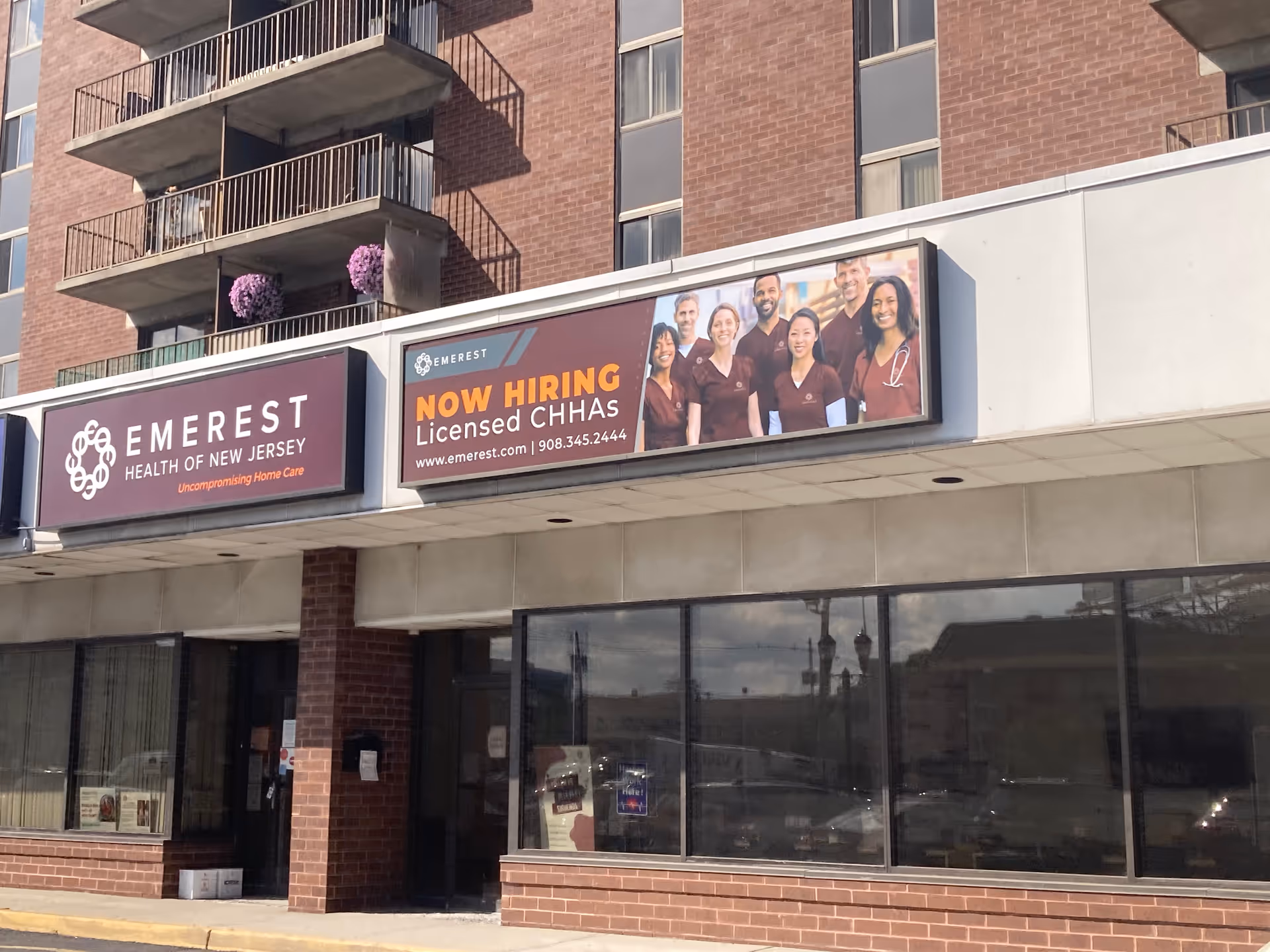 Exterior storefront with Emerest Health banners on a brick building.