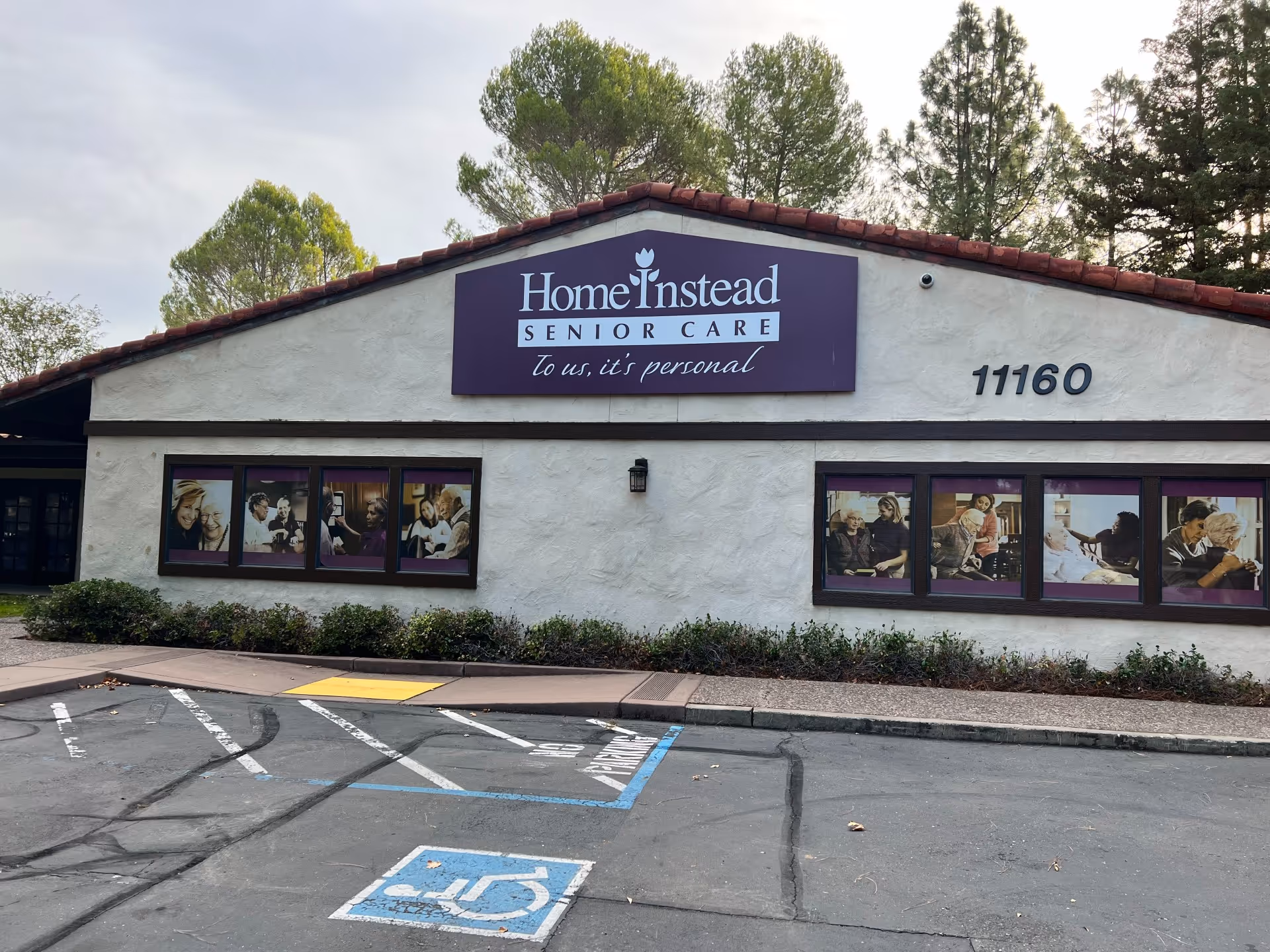 Front view of Home Instead Senior Care building with sign and parking.