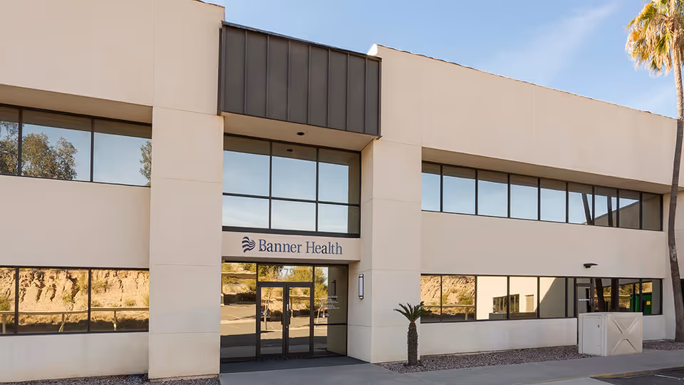 Two-story beige medical building with Banner Health sign and glass entry doors.