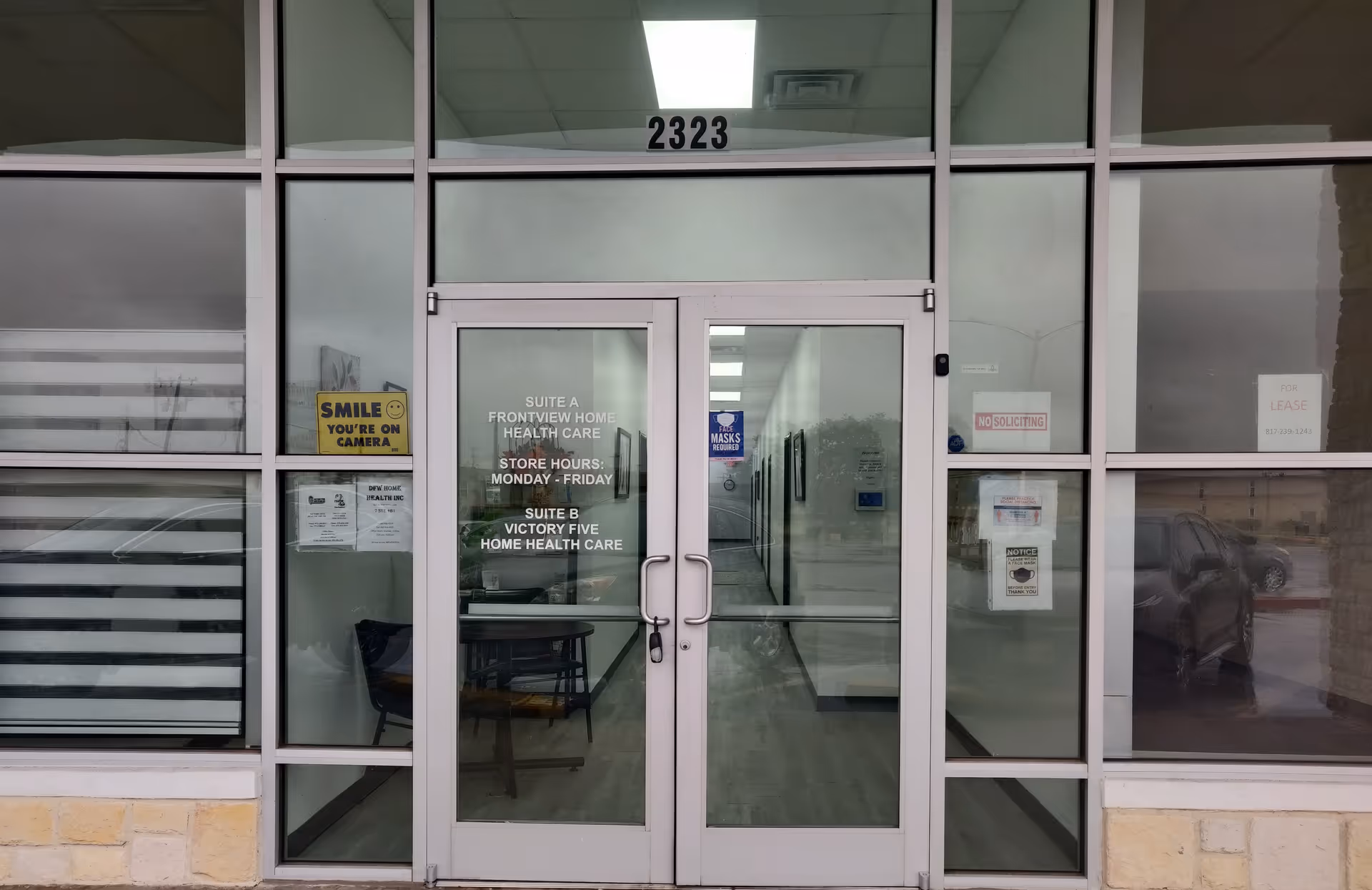 Glass double doors with signage open to a hallway inside Frontview facility.