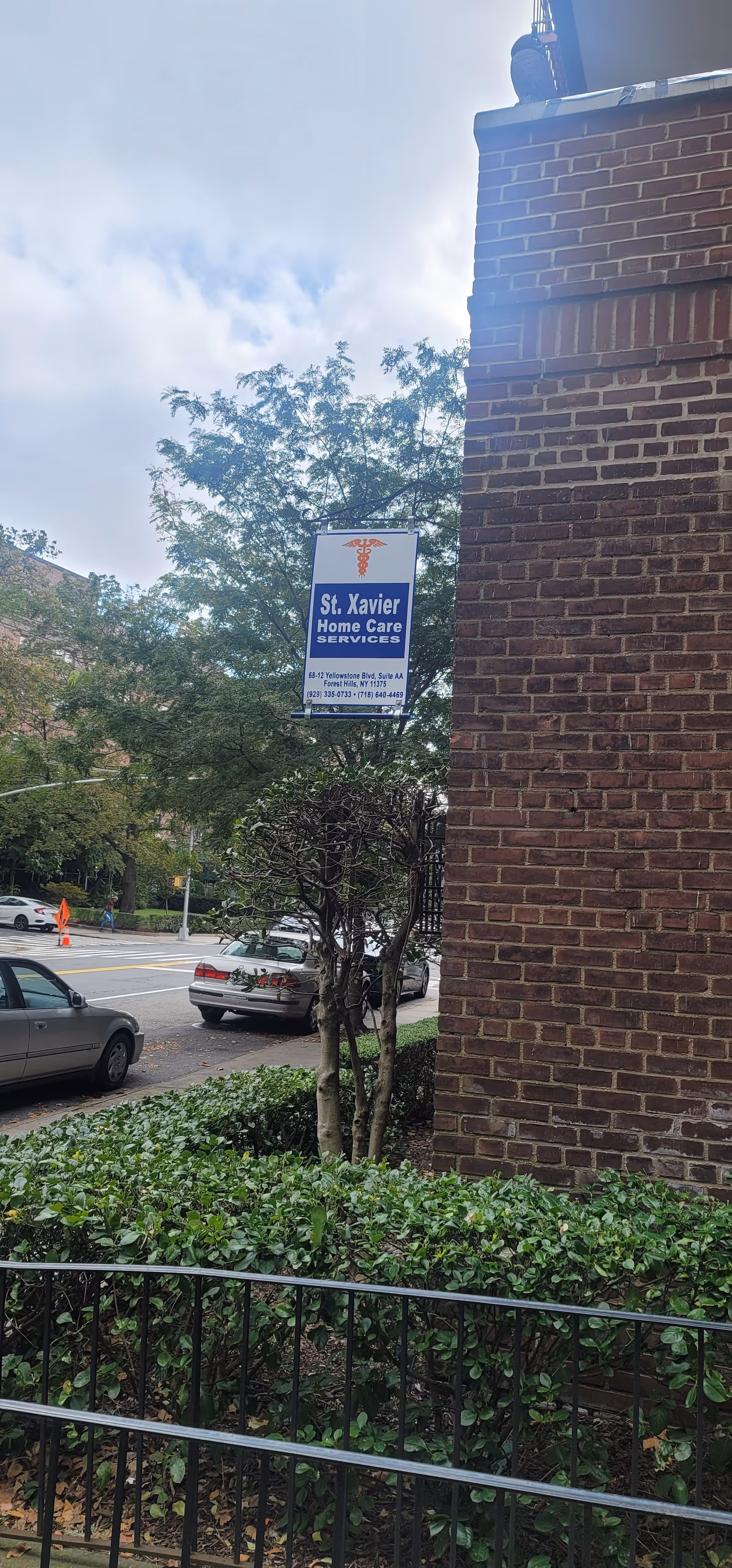 Exterior street view featuring a brick building and a St. Xavier Home Care Services sign