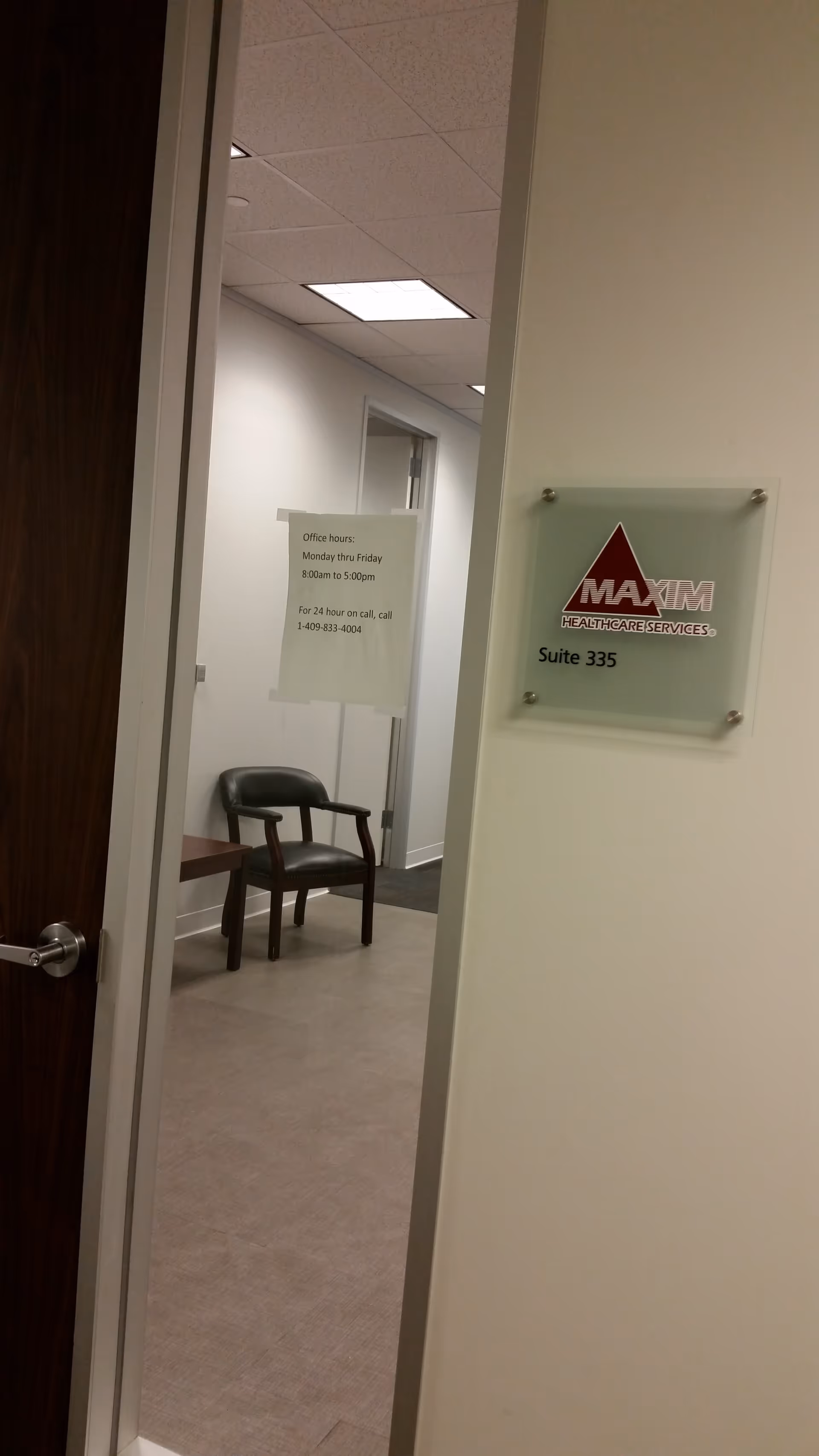 Beaumont office hallway with Maxim Healthcare Services sign and a chair.