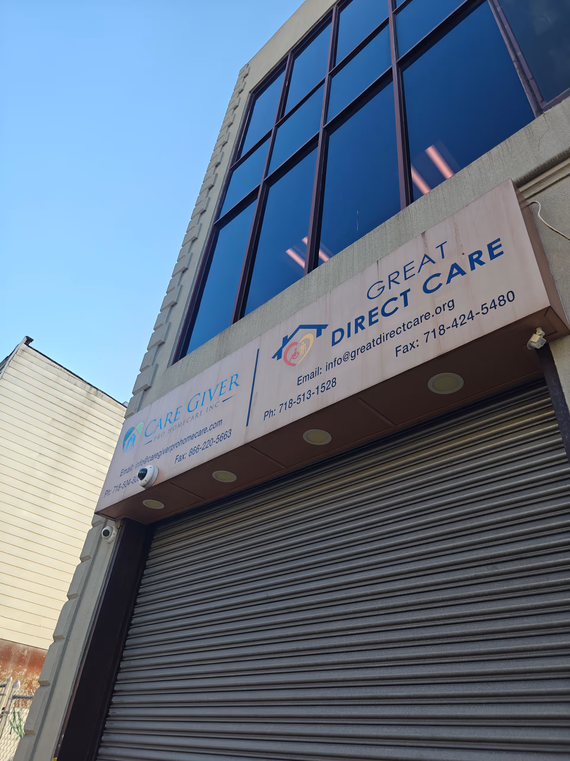 Front view of a building with a large sign advertising Direct Care and Care Giver Pharmacy.