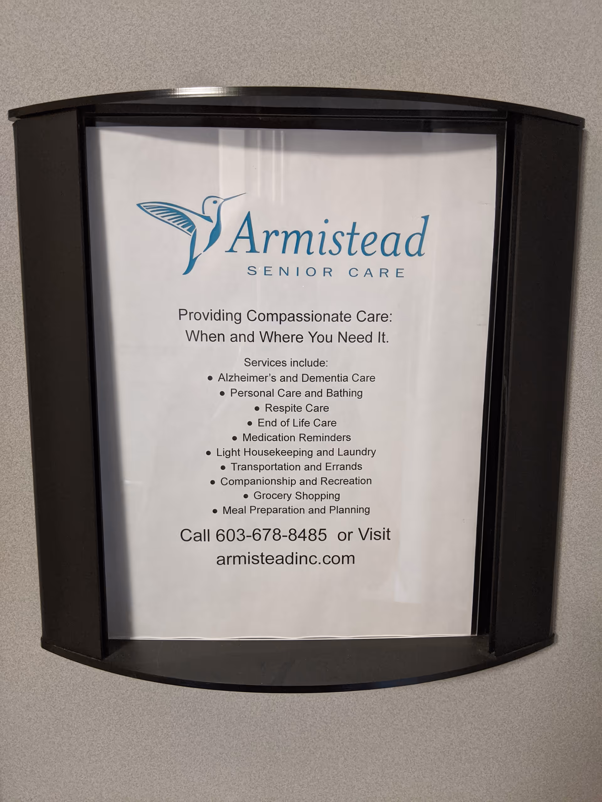 Poster with Armistead Senior Care logo and services displayed in a curved wall frame.