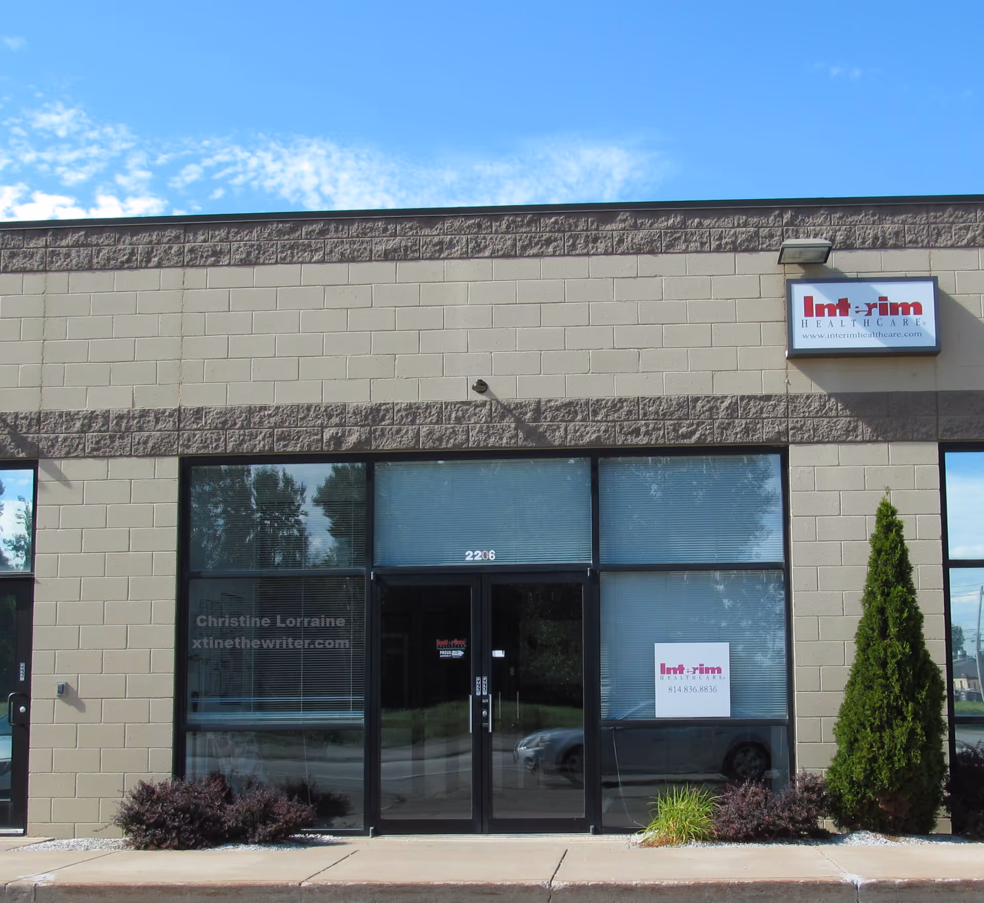 Exterior view of Interim HealthCare building front with glass entrance and sign.