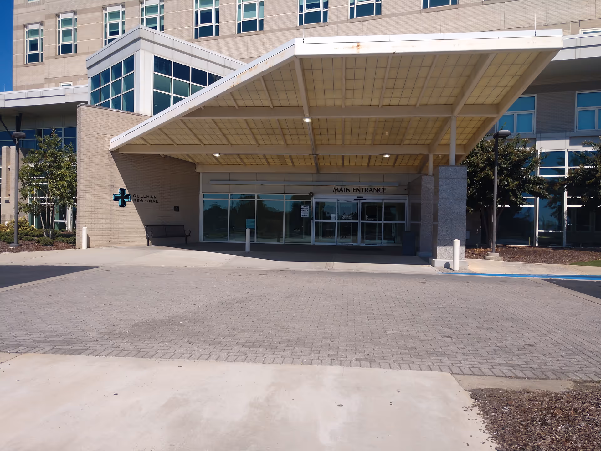 Main entrance of Cullman Regional Medical Center with glass doors and a large canopy.