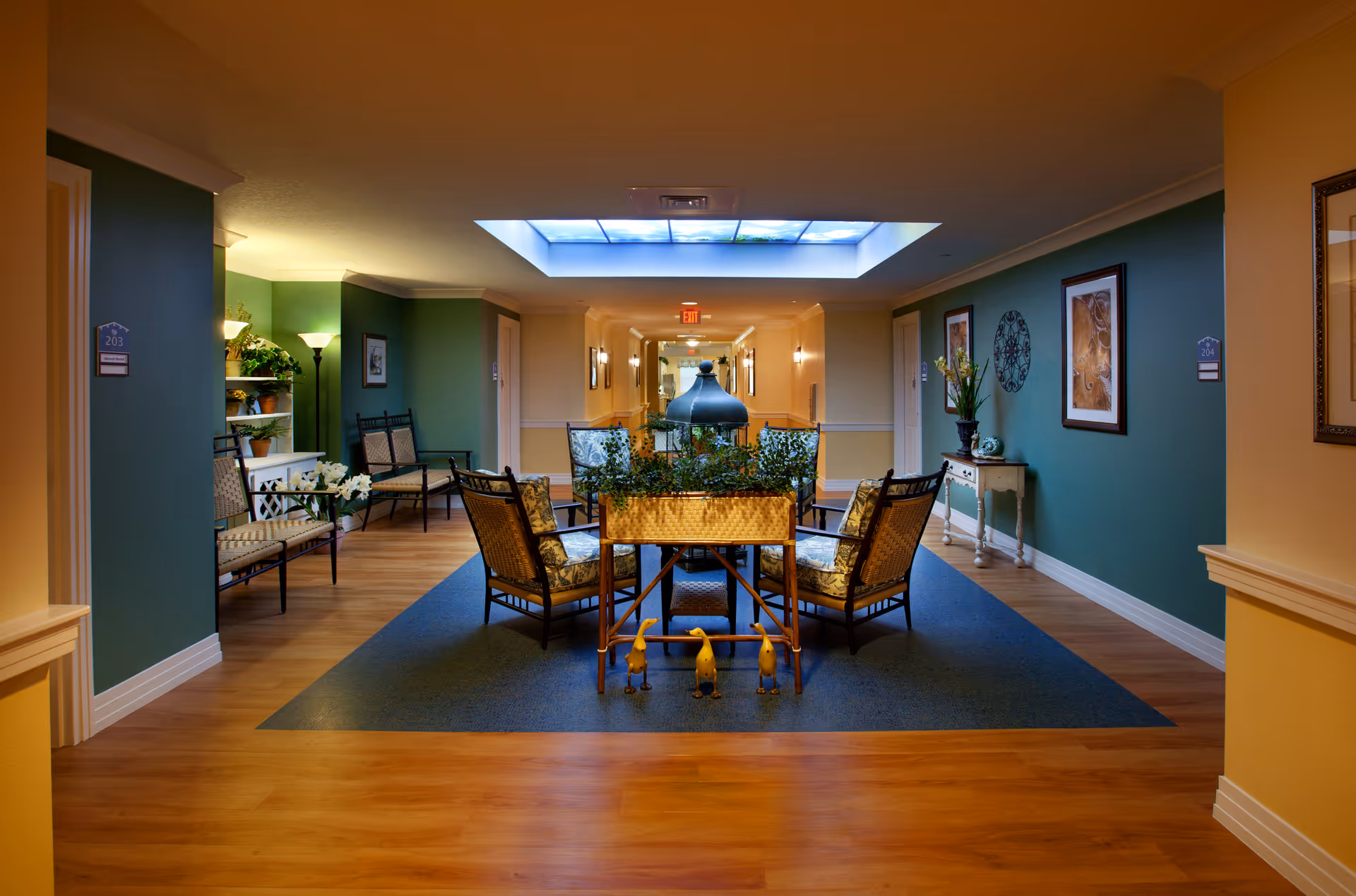 Interior lounge at Serenades at the Villages with seating, plants, and a skylit ceiling.