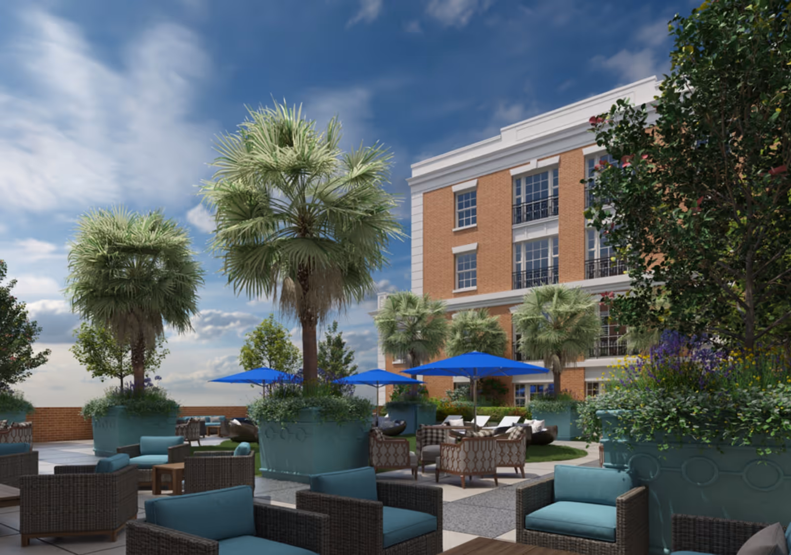 Outdoor courtyard with seating, blue umbrellas, large potted palms, and a brick building in the background.