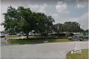Exterior view of Lake Placid Health and Rehabilitation Center with parking and landscaping.