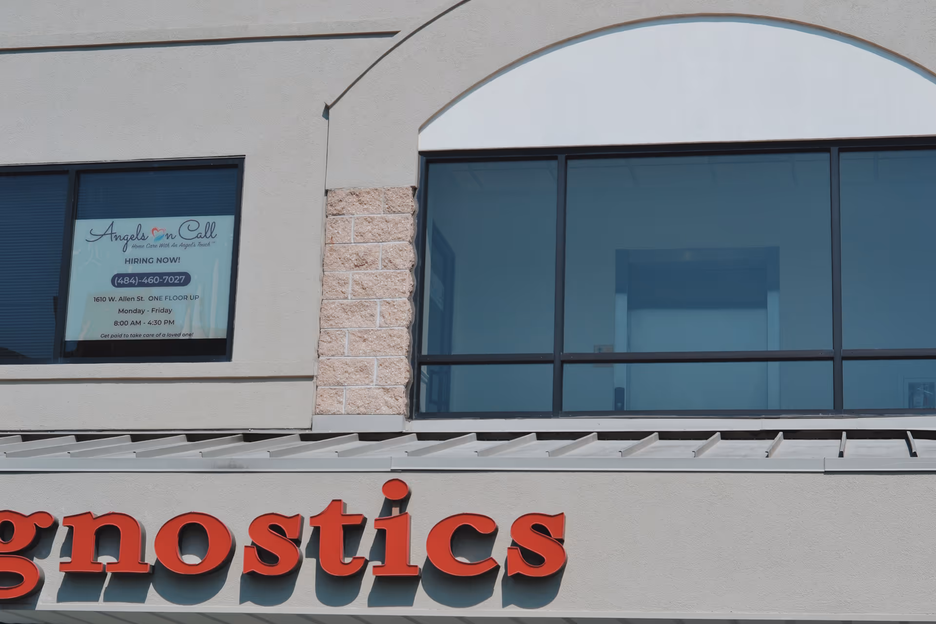 Exterior storefront with large red lettering and Angels On Call Home Care window sign.