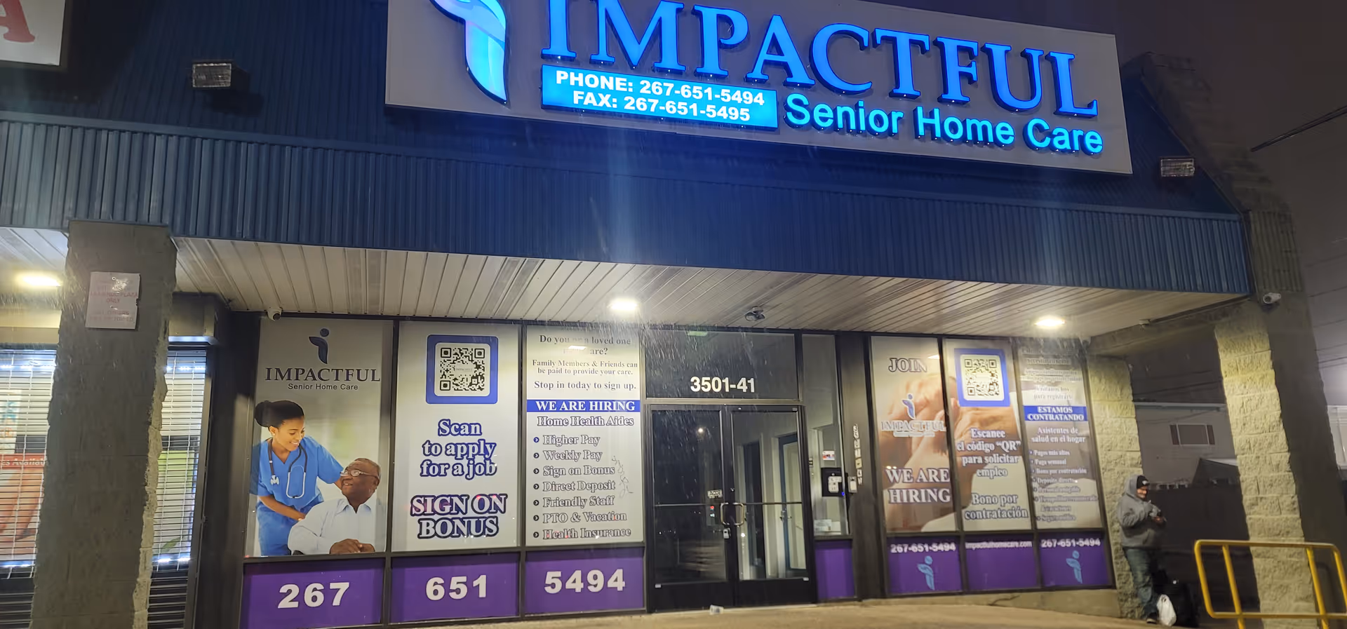 Exterior of Impactful Senior Home Care building featuring illuminated sign and window posters.