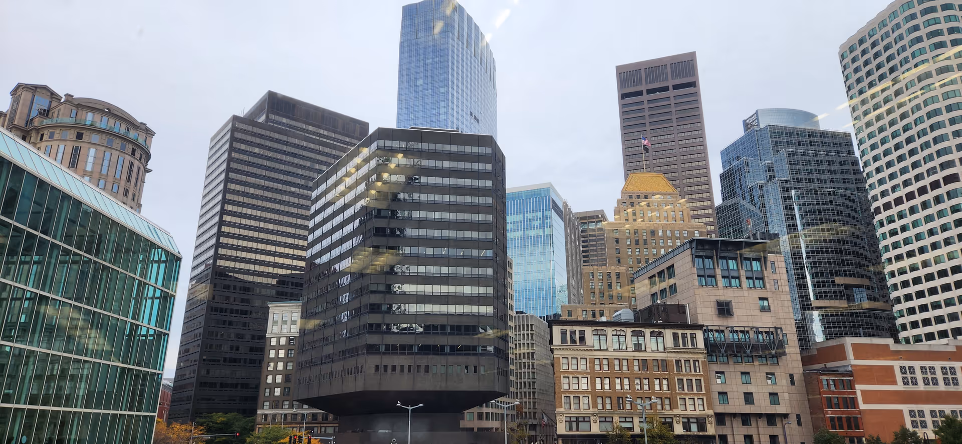 Downtown city skyline with tall glass and concrete office buildings.