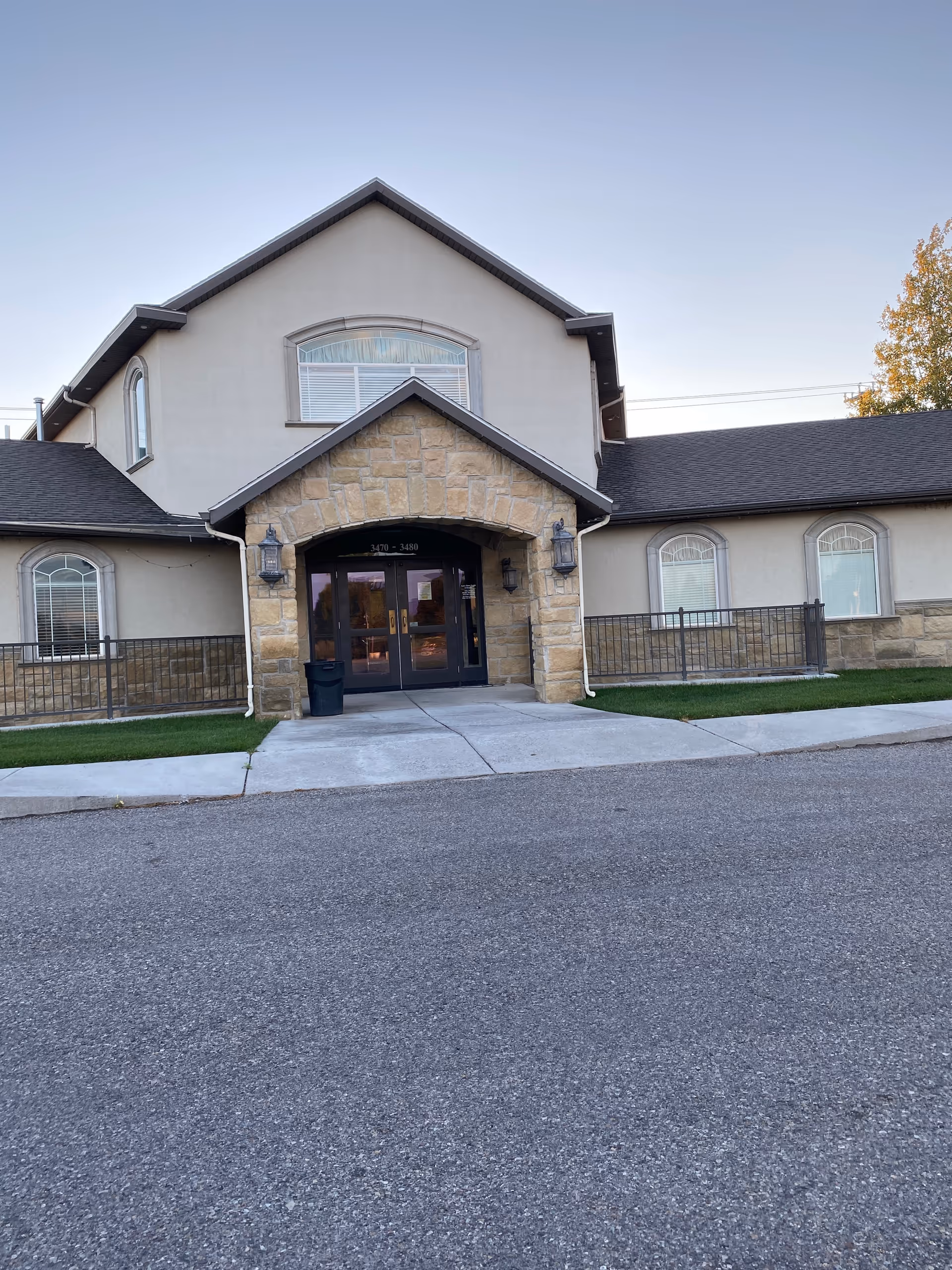 Front view of Aspen Home Health and Hospice facility entrance with stone archway.