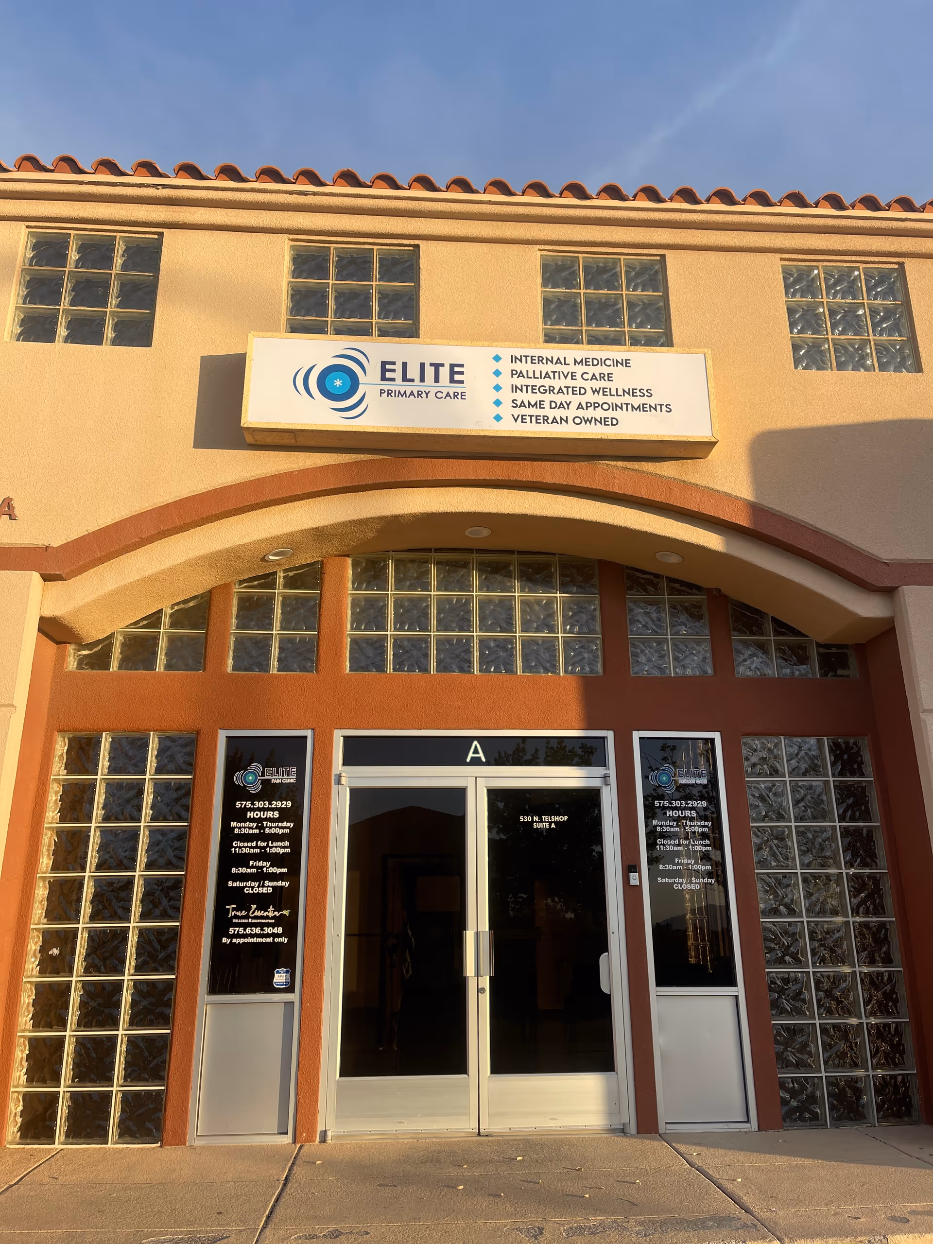 Exterior view of Elite Primary Care building with arched entrance and sign on the facade.