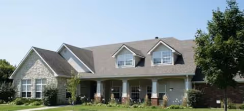 Front exterior of a Brookdale senior living building with stone accents and a covered entry.
