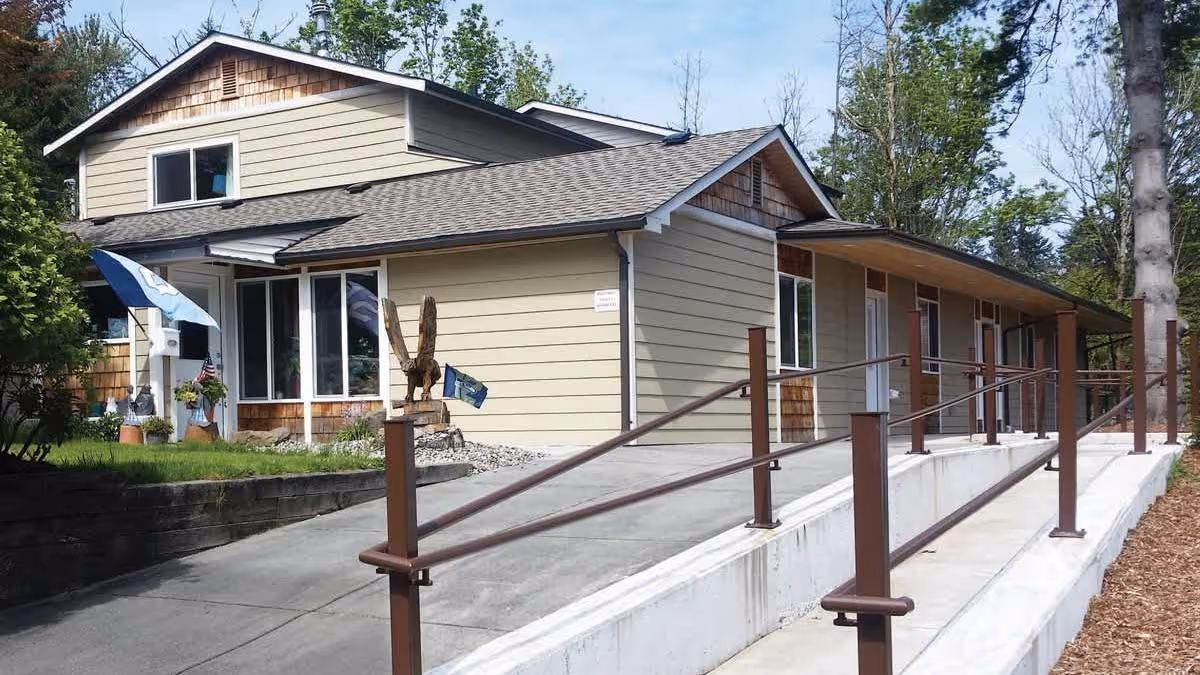 Exterior view of Mountlake Terrace AFH: a single-story beige building with ramp and rails.