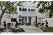 Front entrance of Worcester Rehabilitation & Health Care Center with outdoor seating and umbrellas.