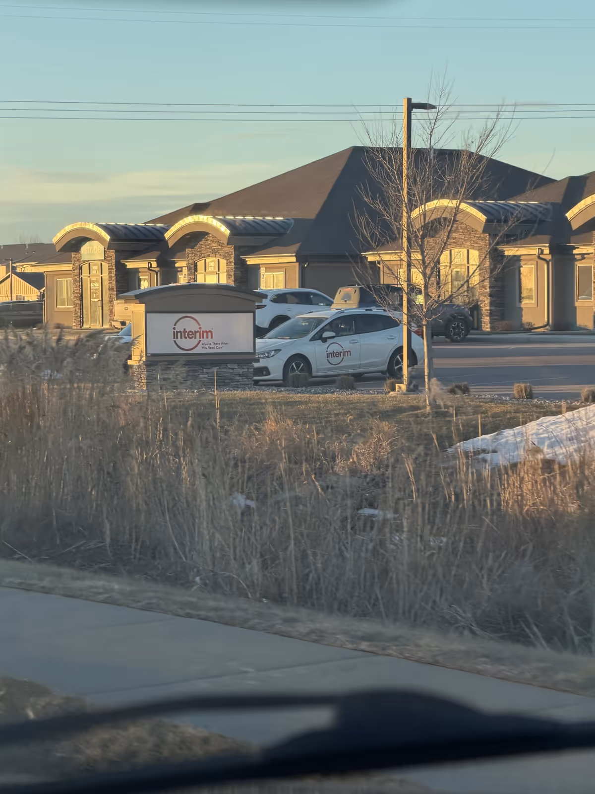 Front exterior view of Interim HealthCare of Sioux Falls with parked cars.