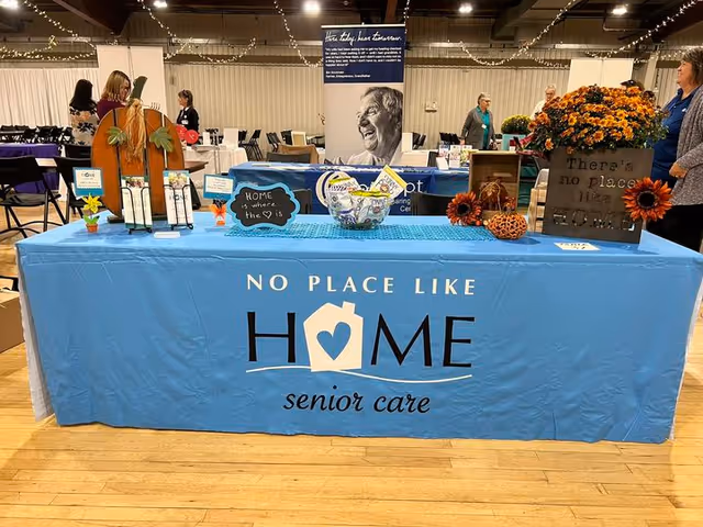 Blue No Place Like Home senior care booth at an indoor expo.
