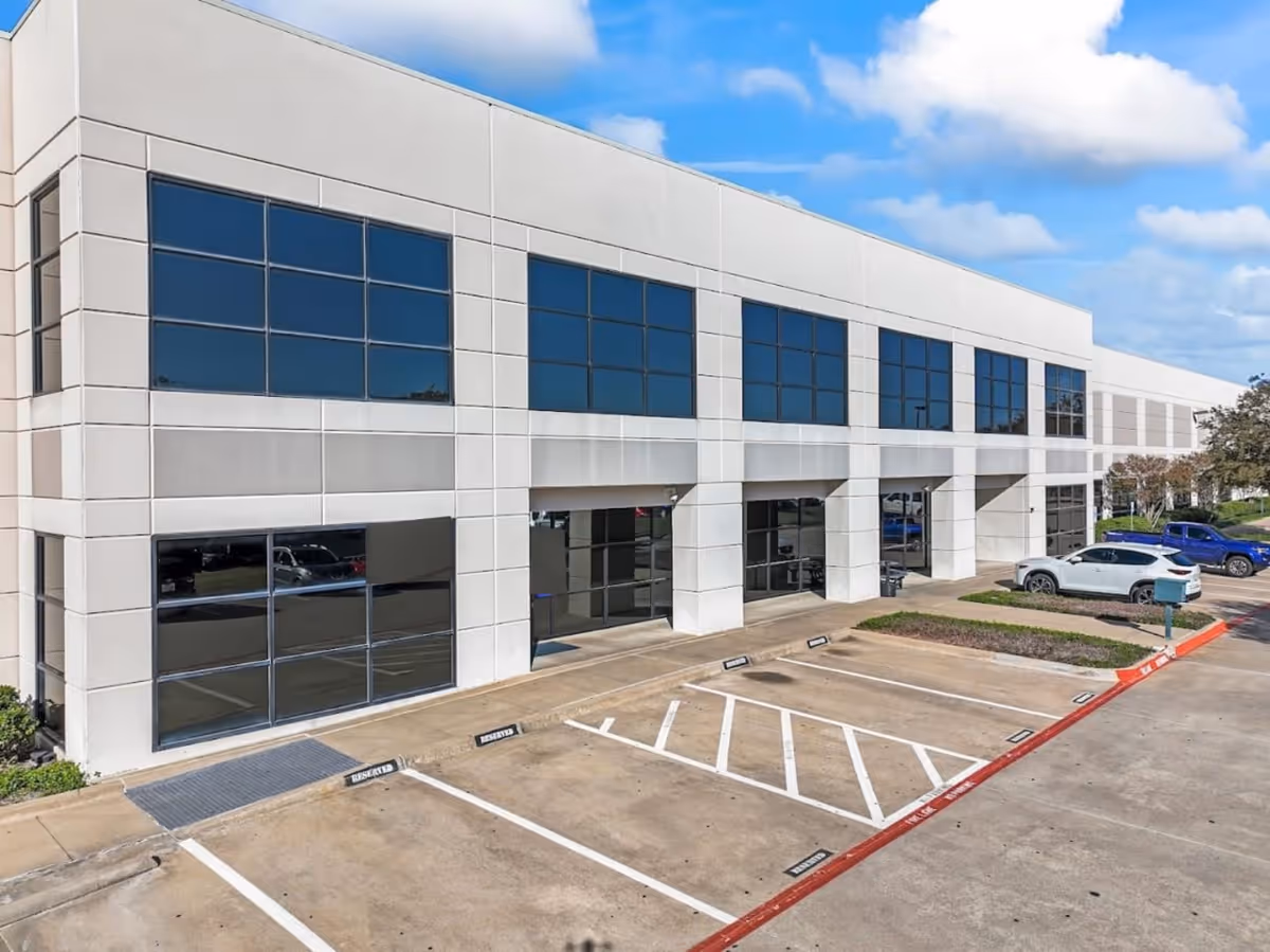 Modern white exterior of Velara Care building with large blue windows and parking.
