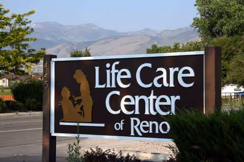 Front exterior sign for Life Care Center of Reno with mountains in background