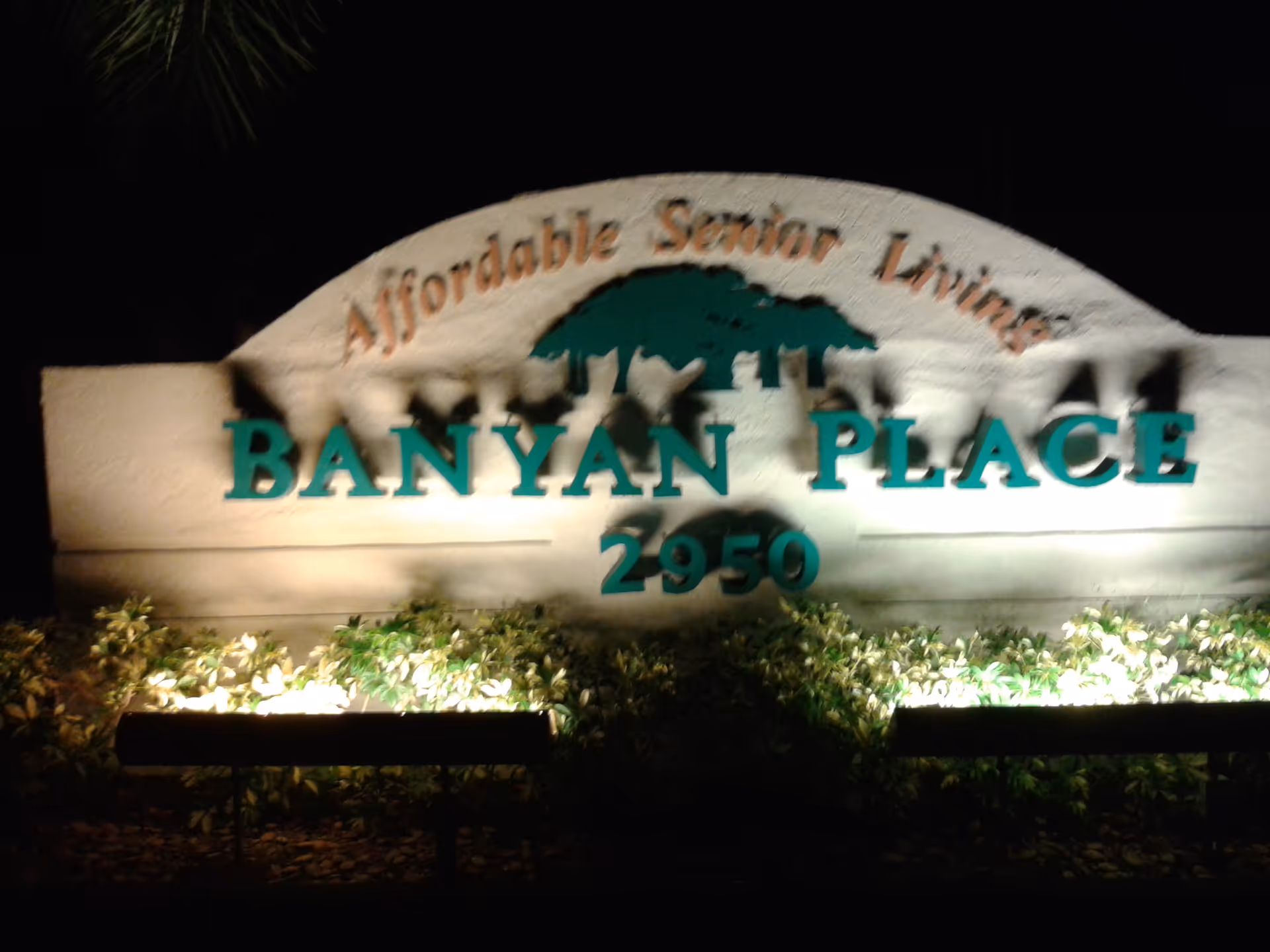 Nighttime sign for Banyan Place Affordable Senior Living with the address 2950.