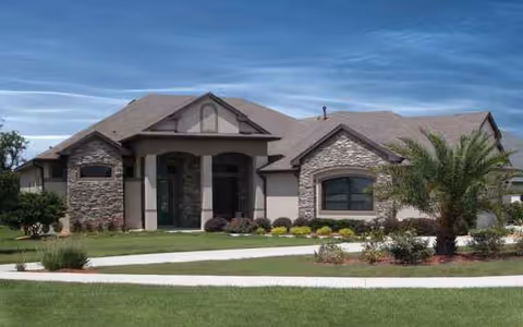 Front view of Lakes of Mount Dora senior living facility with landscaped lawn.