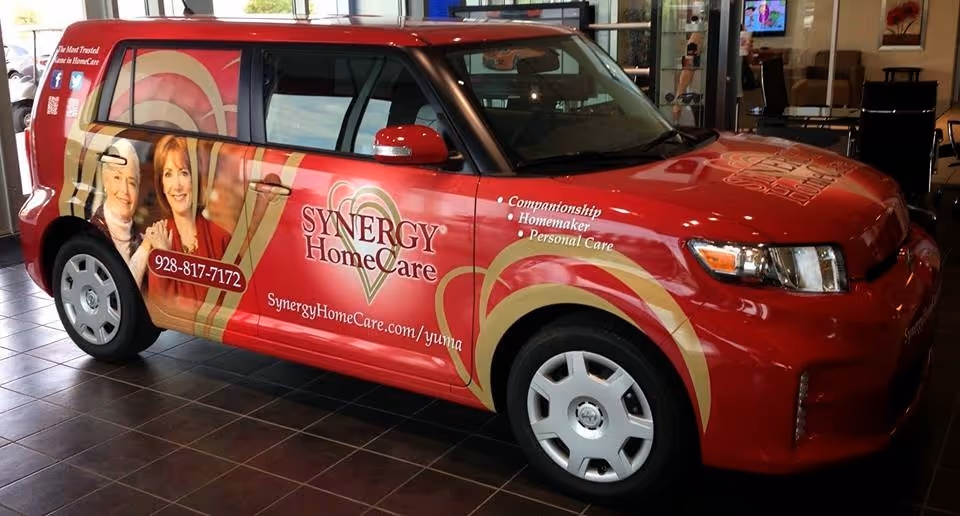 Red Synergy HomeCare van on display inside a facility showroom.