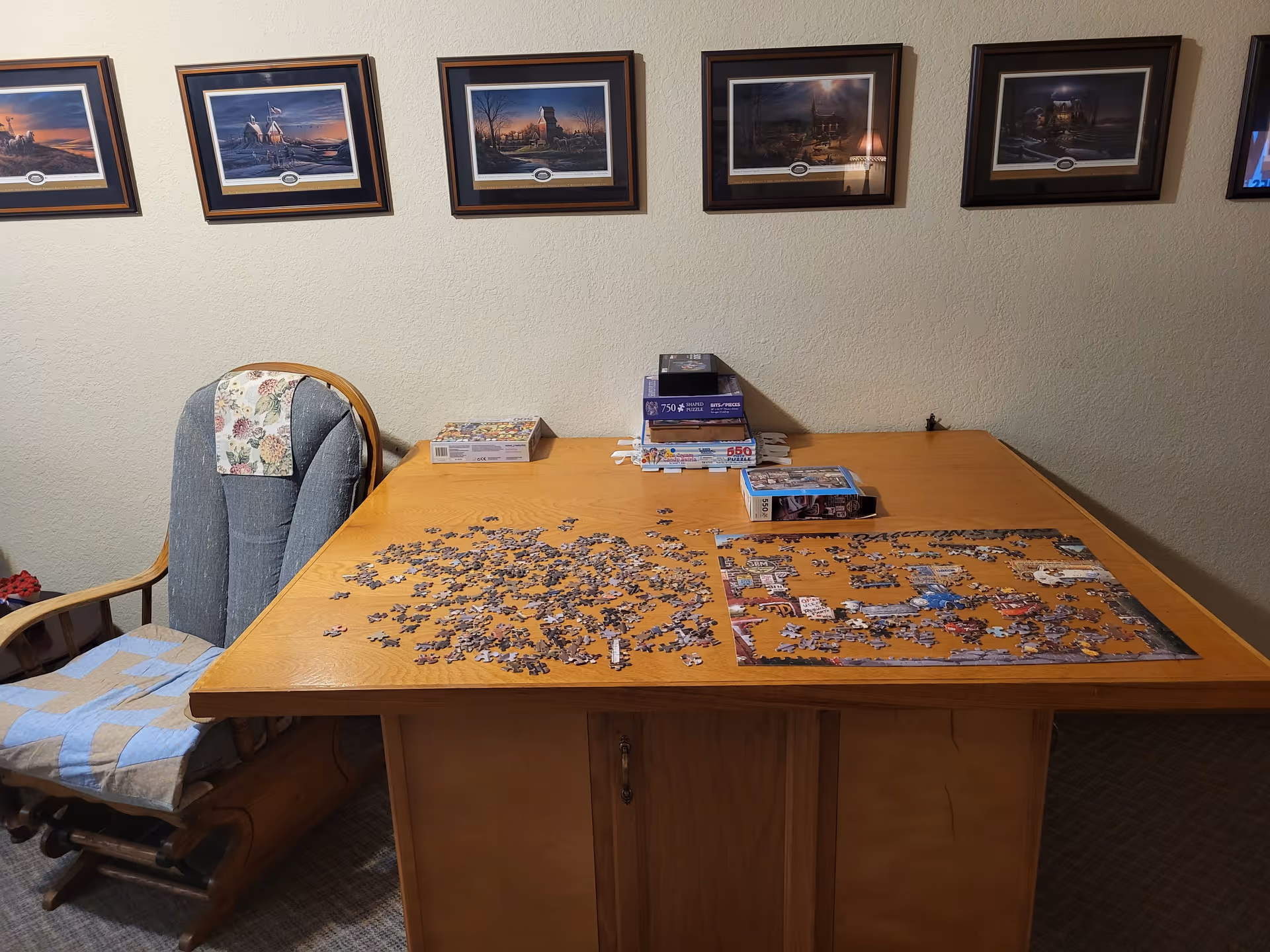 Common area at a senior living facility with a jigsaw puzzle spread across a wooden table.