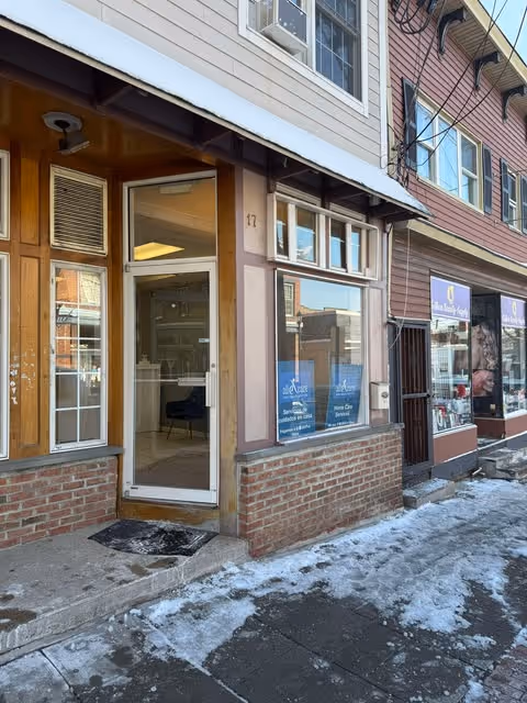 Exterior storefront with entrance to All Care Home Health Services on a snowy street.