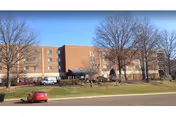 Exterior of Majestic Oaks Rehabilitation and Nursing Center with brick facade and parked cars.
