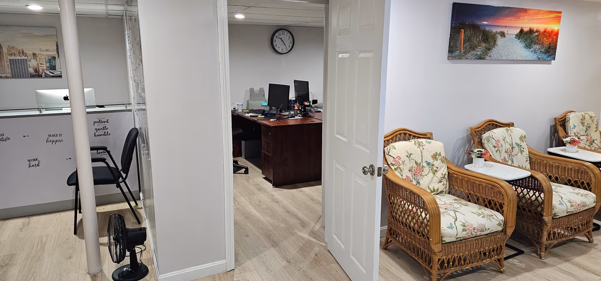 Interior lounge area of Humble Home Care Services with wicker chairs and desk workspace.