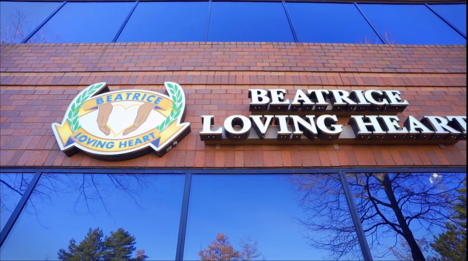 Beatrice Loving Heart facility sign sits on a brick building exterior.