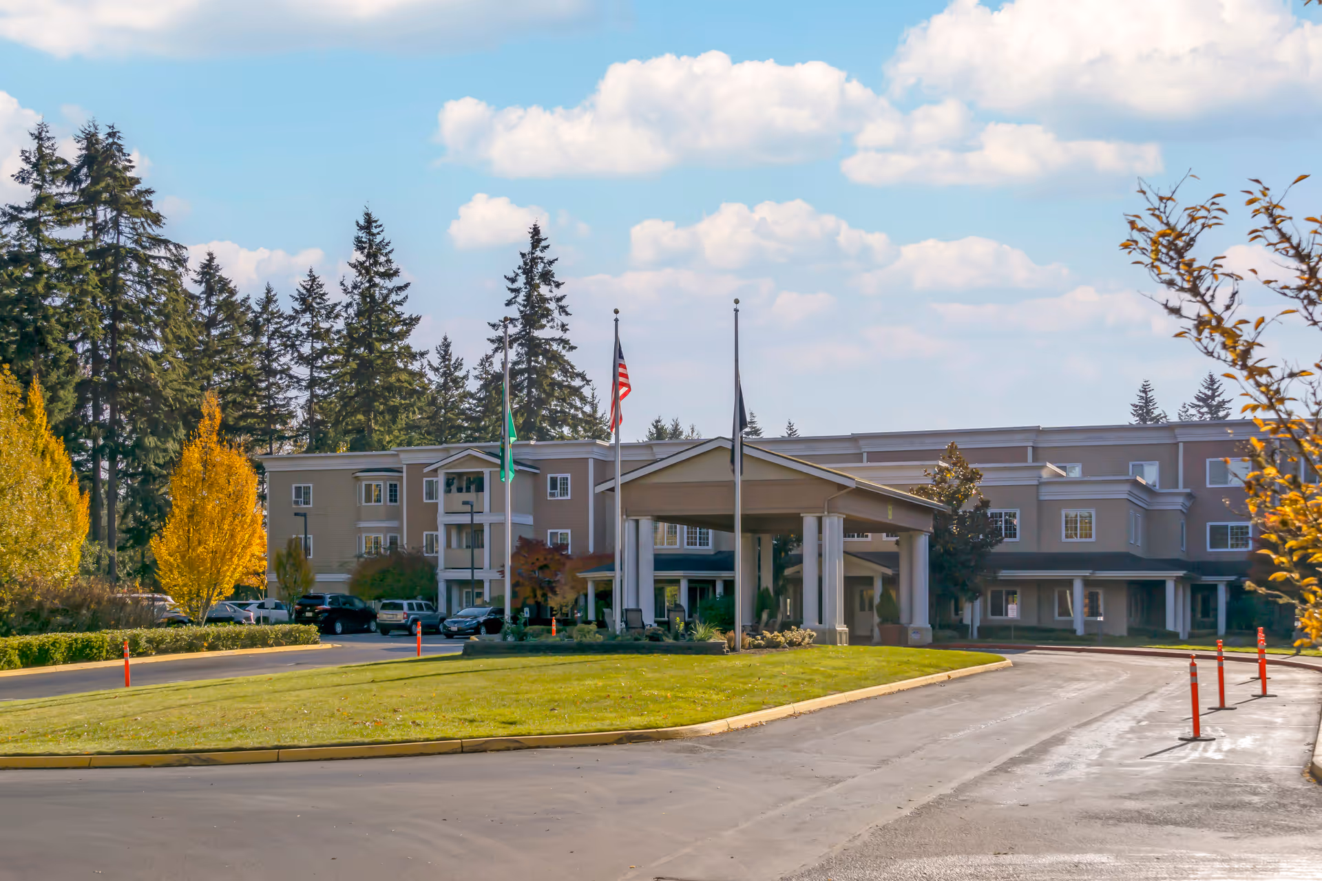 Exterior view of Brookdale Foundation House with entrance canopy and flagpoles.