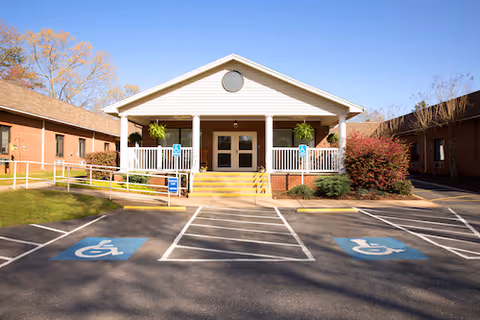 Exterior front of Autumn Care of Marion showing accessible parking and a ramped entrance.