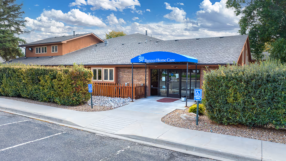 Exterior view of Banner Home Care building with blue entrance canopy and landscaping.