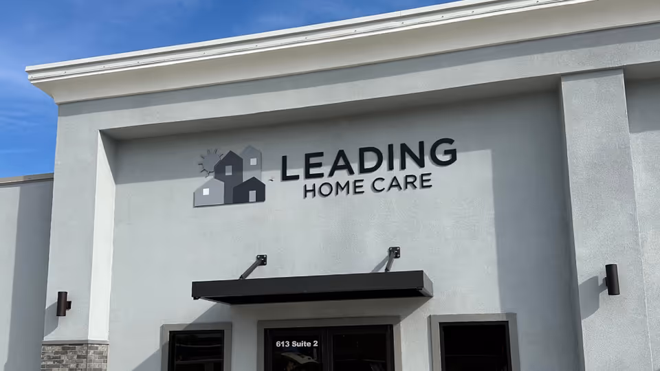 Exterior view of a building with a Leading Home Care sign and entrance.