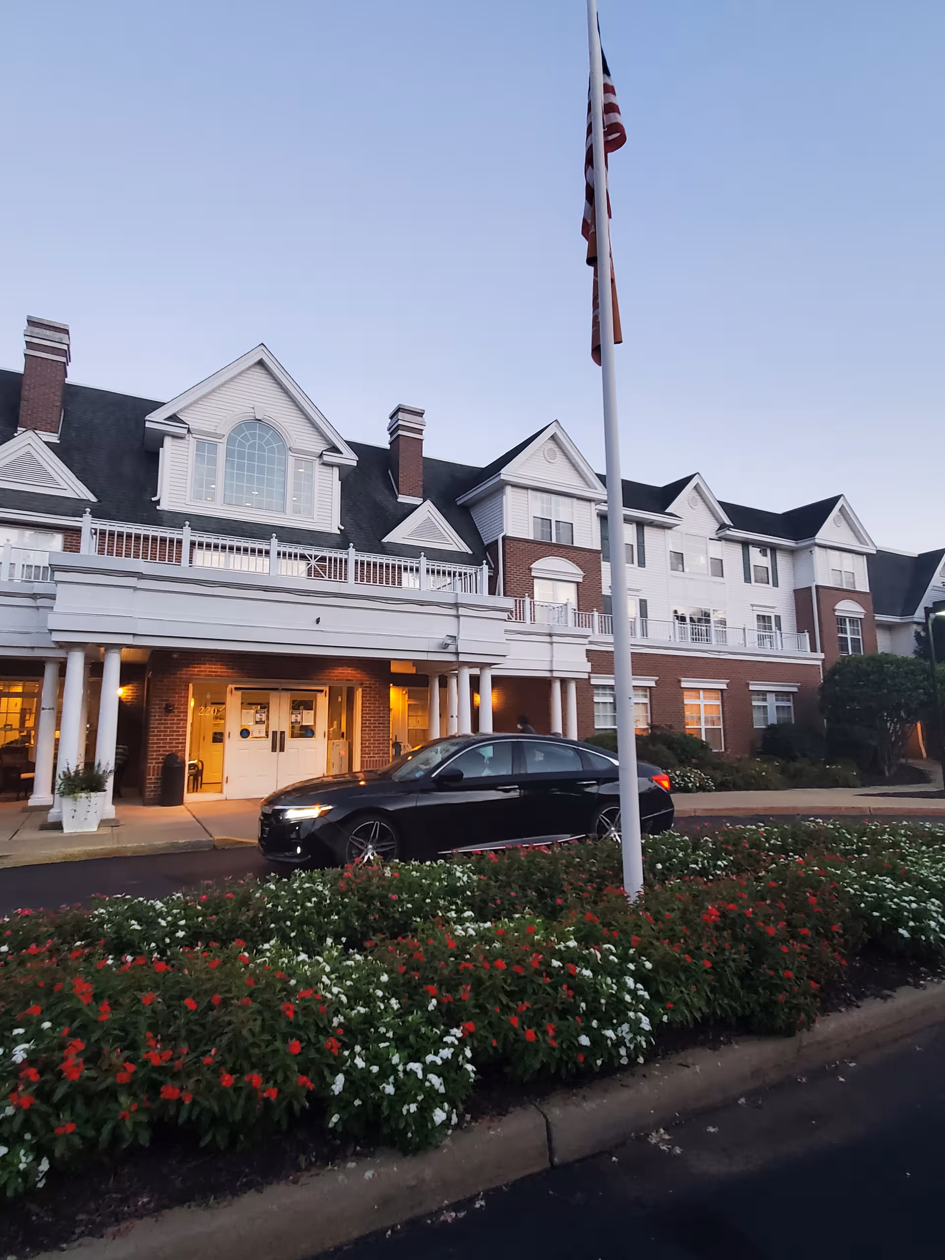 Exterior view of Brighton Gardens of West Orange showing entrance and landscaped front.