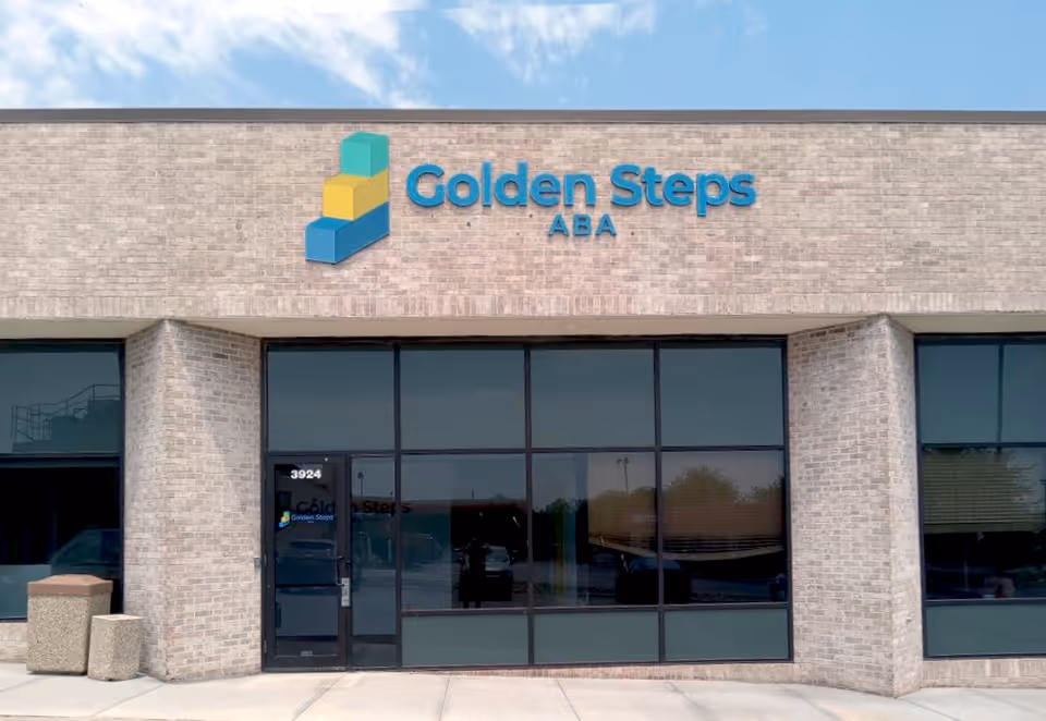 Exterior view of Golden Steps ABA building with brick facade and large glass windows.