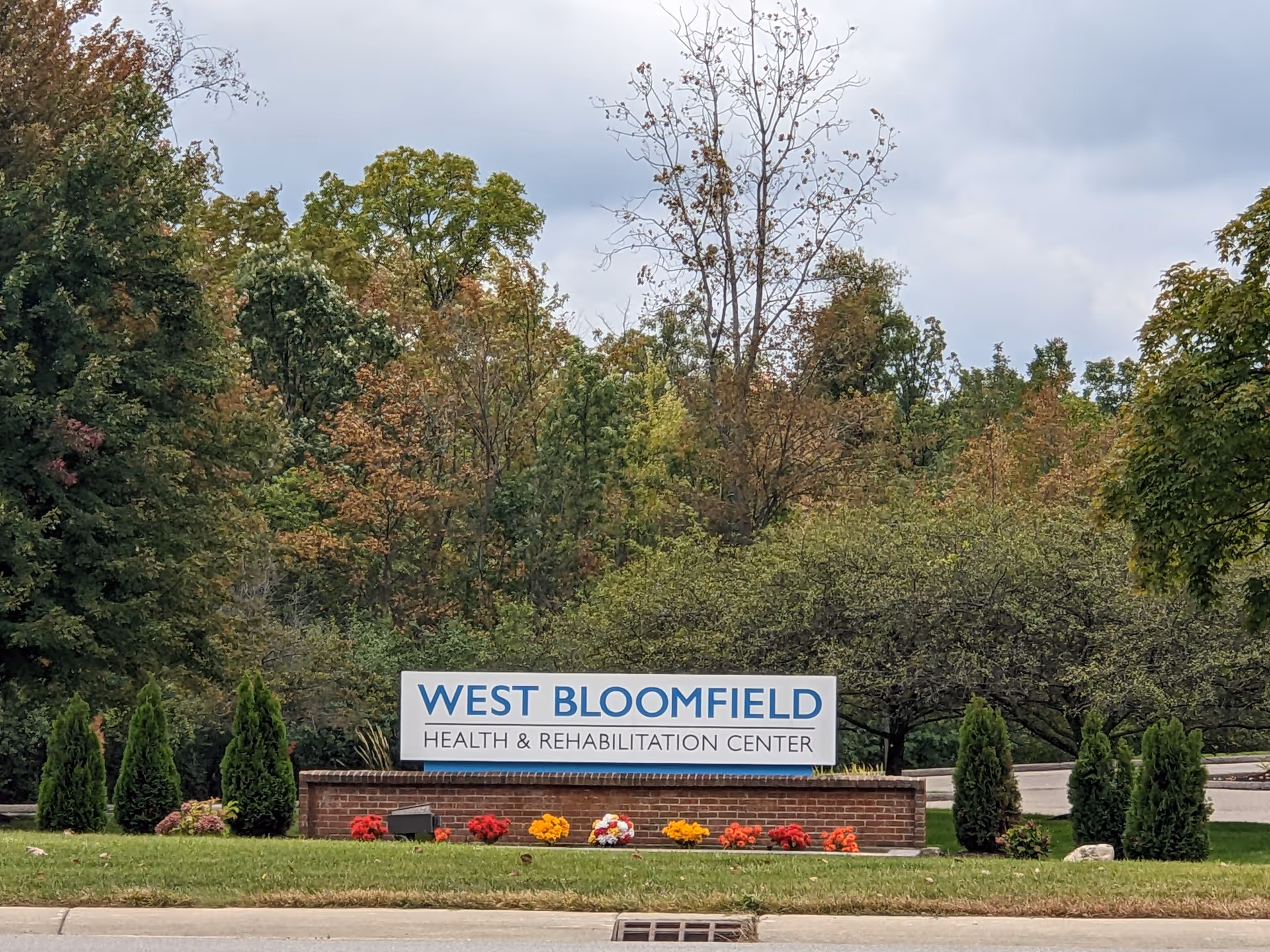 West Bloomfield Health & Rehabilitation Center sign with landscaping and flowers