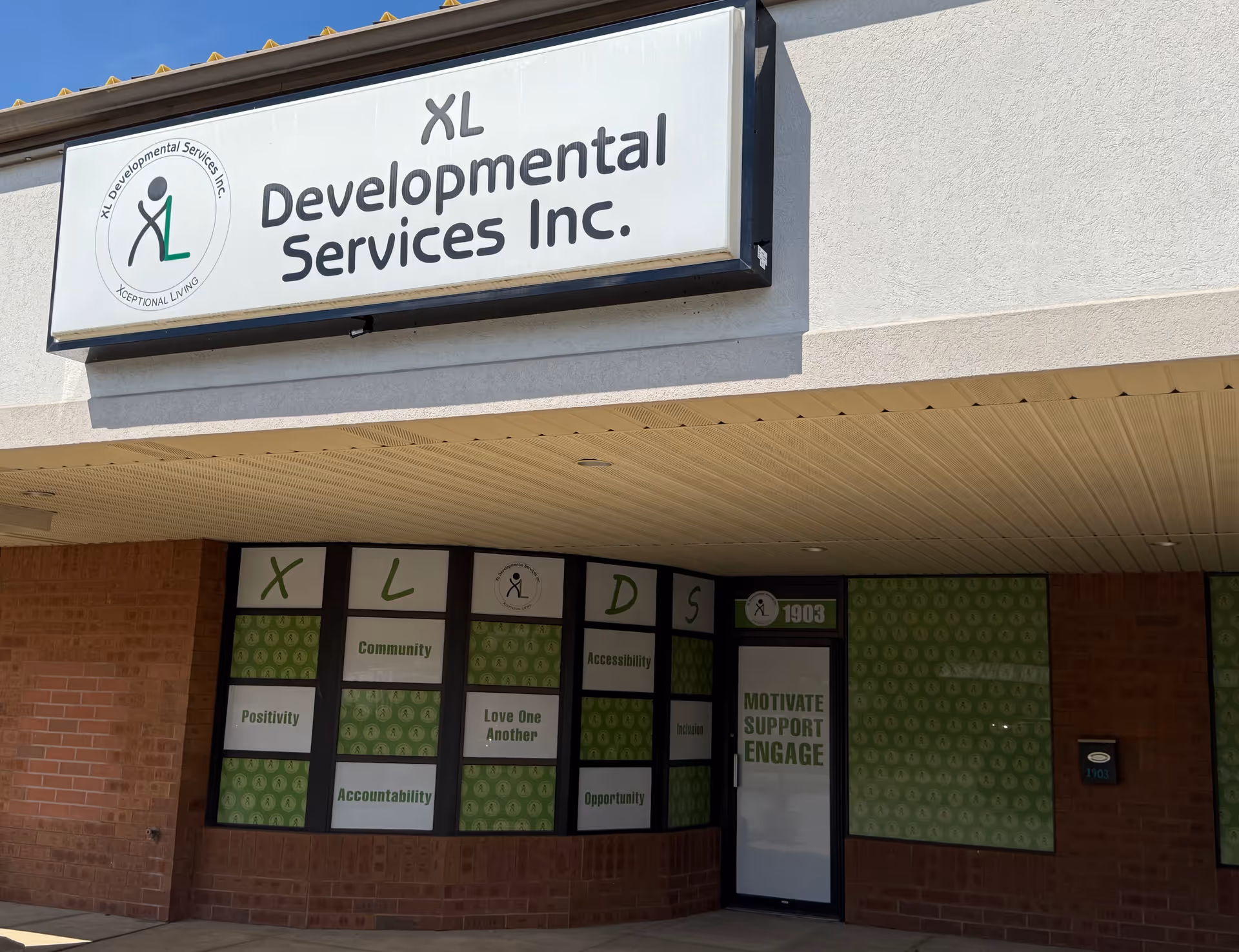 Exterior of XL Developmental Services Inc. building with large sign above the entrance.