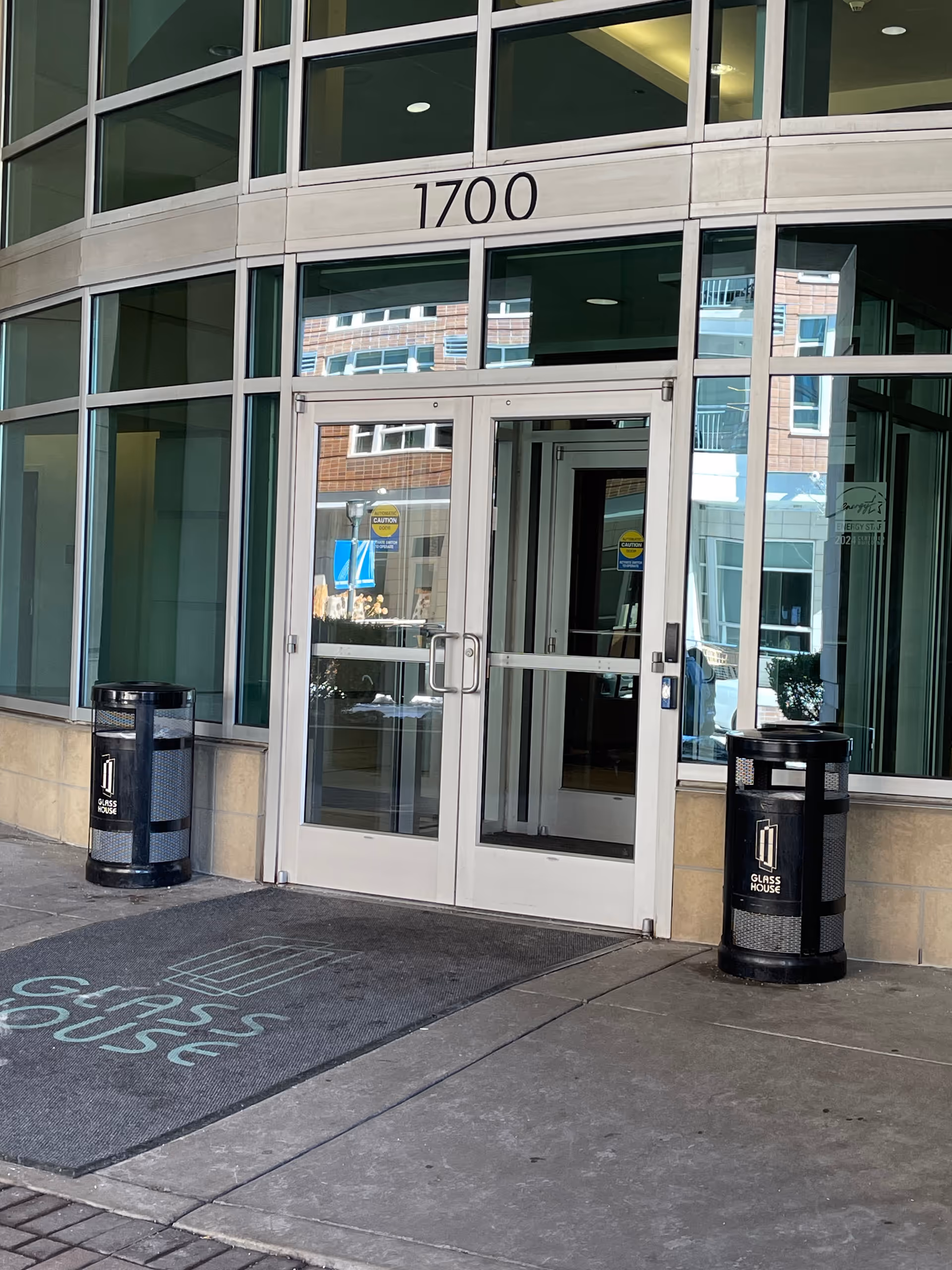 Modern glass building entrance with 1700 above the door.