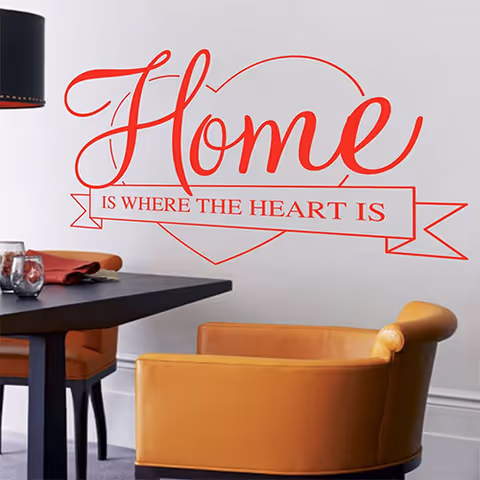 Two tan armchairs sit beside a dark table in a modern lounge with wall art.