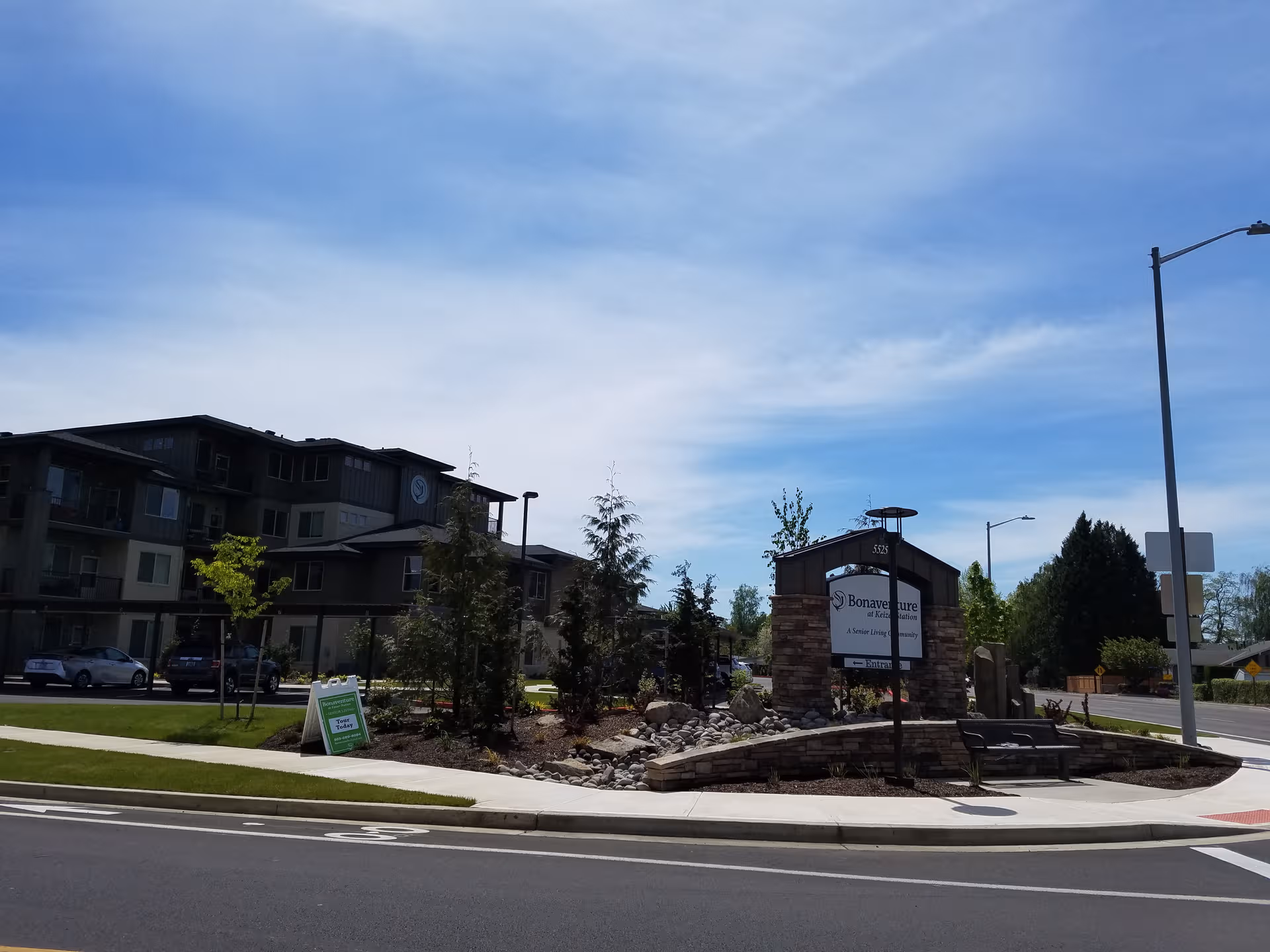 Exterior view of Bonaventure at Keizer Station with entrance sign and landscaped roundabout