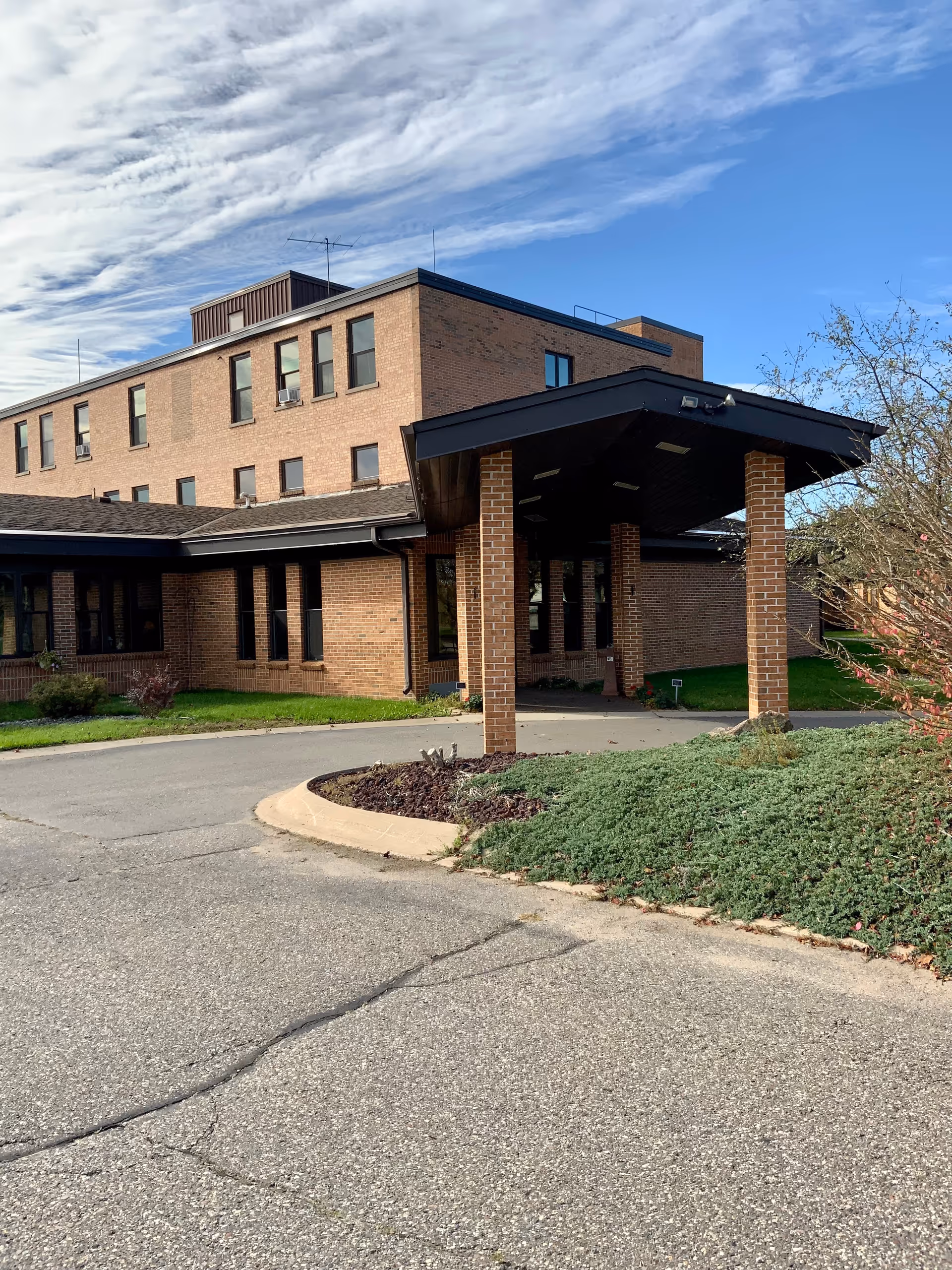Exterior view of Iron Co Medical Care Facility with covered entrance and landscaped grounds.