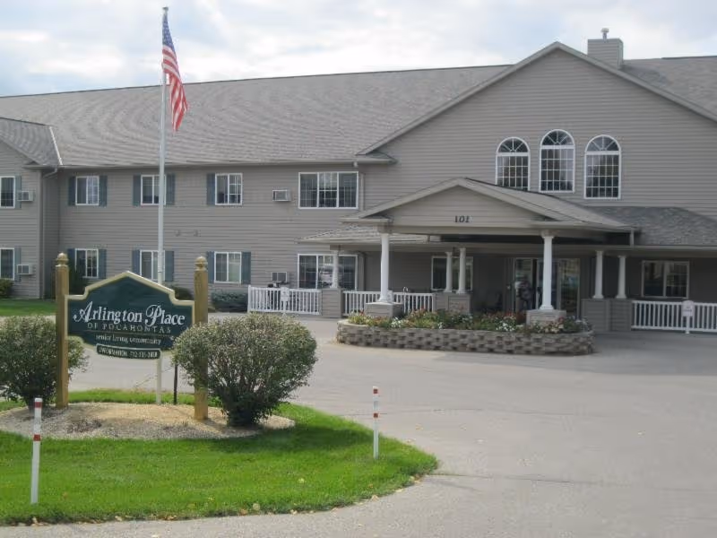 Exterior view of Arlington Place at Pocahontas building with flag and entrance canopy.