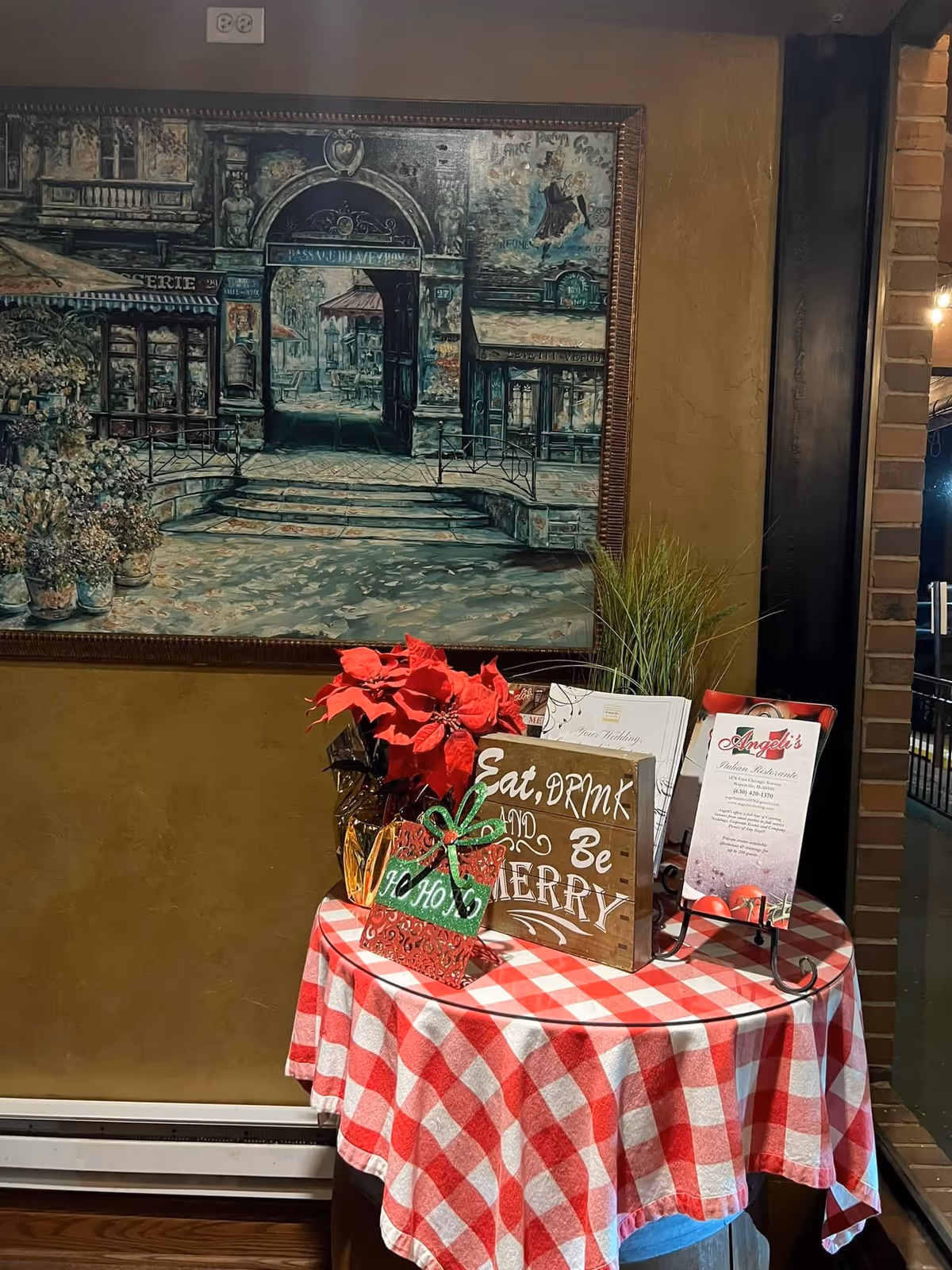 Interior scene with holiday table decor and a framed street mural.